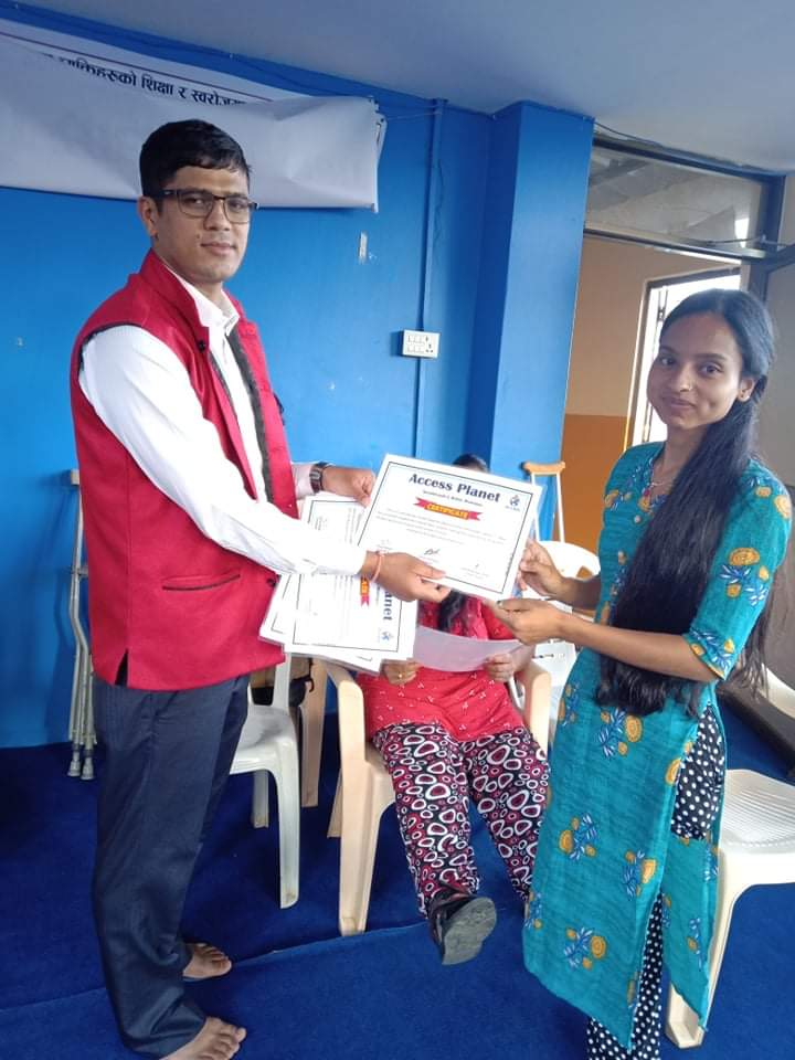 Computer trainee receiving certificate from computer trainer Mr. Arjun Acharya.