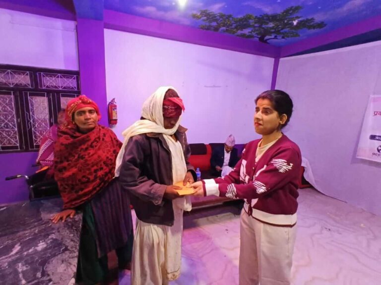 Gargi Nepal is handing over the support, and the support recipient and her family member are also present in the photo.