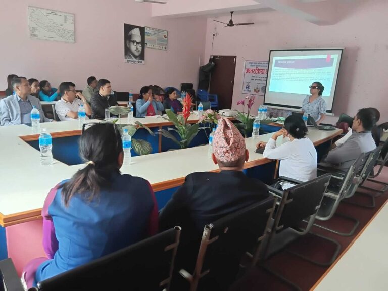 Laxmi Nepal is presenting, and all participants are in the photo. The banner is also visible in the photo.