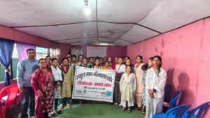 Group picture of participants with banner along with trainer