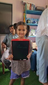 Small girl holding Writing Tablet in her hand